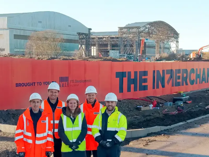 YTL team stood in front of the The Interchange office under construction